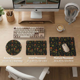 Dark forest-themed desk mat with an all-over pattern of frogs, mushrooms, fern leaves, acorns, tiny flowers, and antique keys.