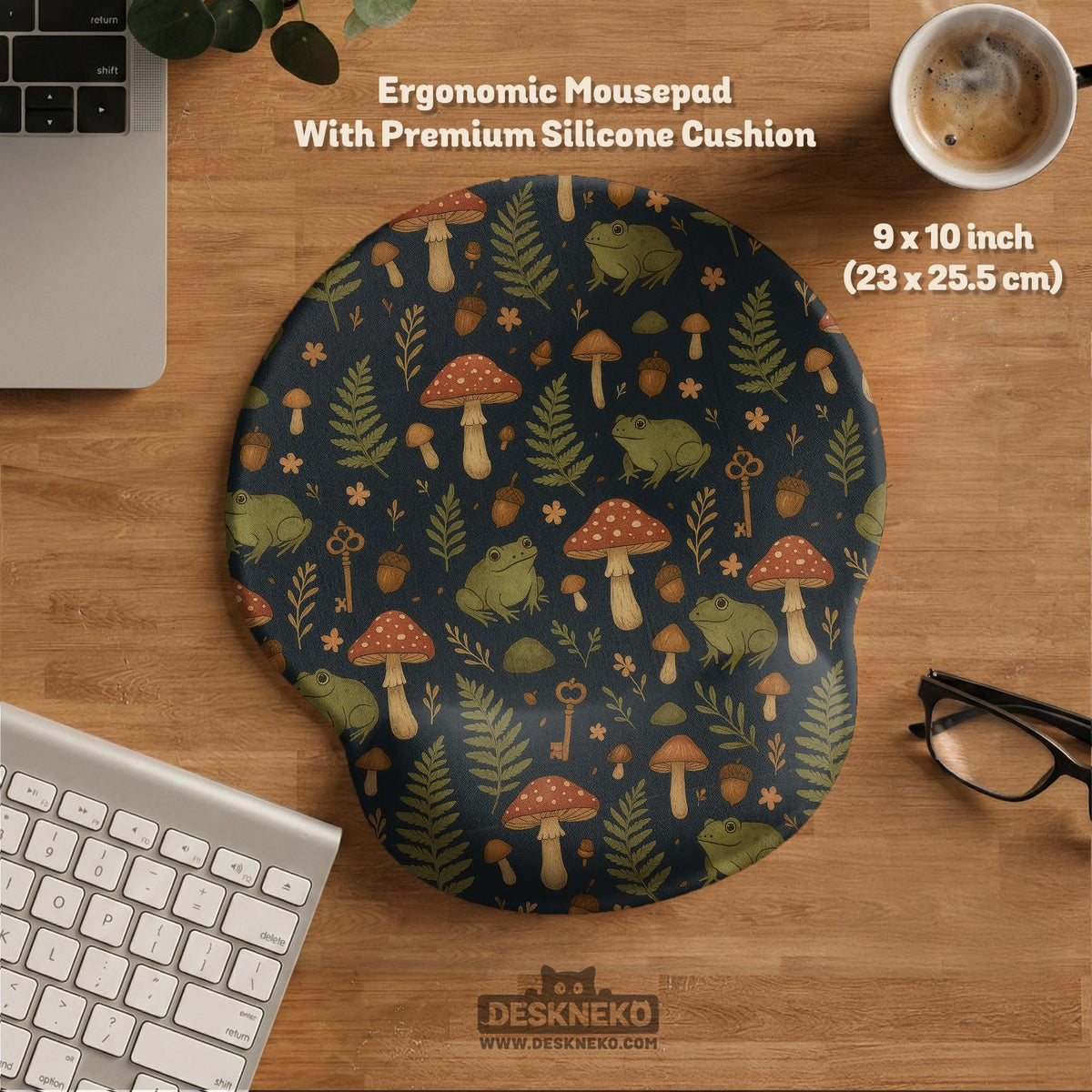 Dark forest-themed desk mat with an all-over pattern of frogs, mushrooms, fern leaves, acorns, tiny flowers, and antique keys.