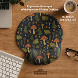 Dark forest-themed desk mat with an all-over pattern of frogs, mushrooms, fern leaves, acorns, tiny flowers, and antique keys.