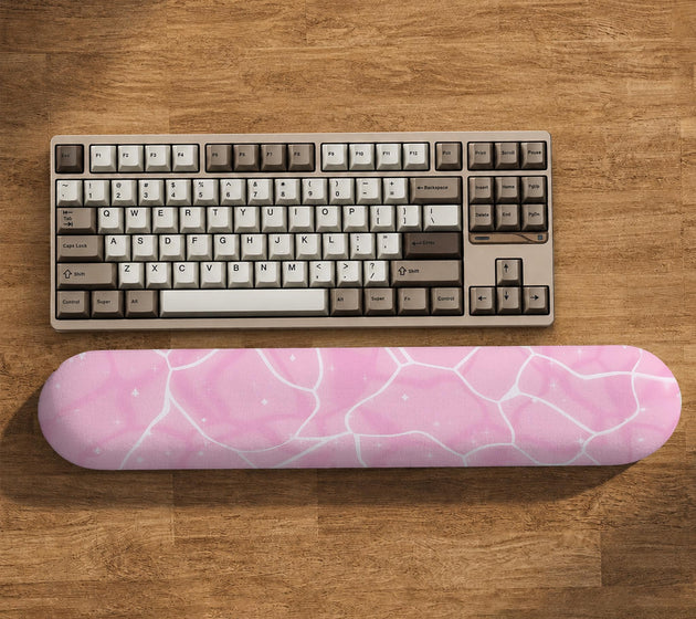 Soft pink mouse pad and wrist rest with a cloud-marble pattern, pale linework, and small star details.