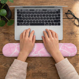 Soft pink mouse pad and wrist rest with a cloud-marble pattern, pale linework, and small star details.