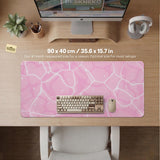 Pastel pink desk mat with a marble-style design, white flowing lines, and small sparkle accents.