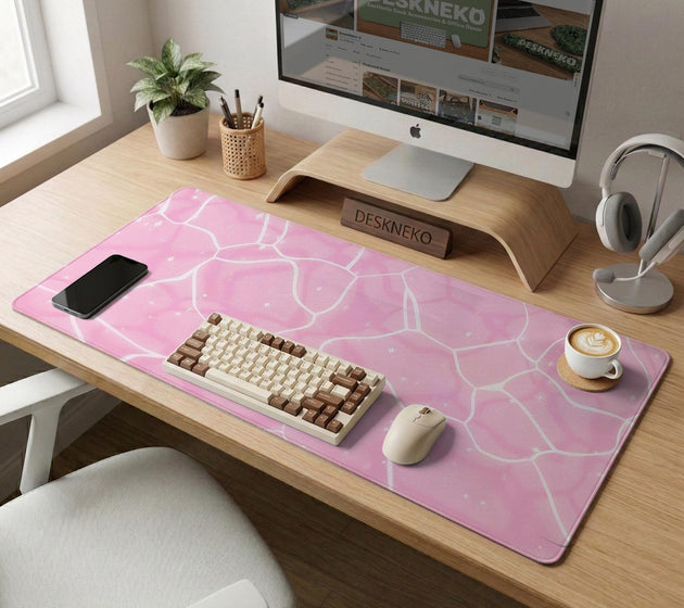 Pastel pink desk mat with a marble-style design, white flowing lines, and small sparkle accents.