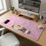 Pastel pink desk mat with a marble-style design, white flowing lines, and small sparkle accents.