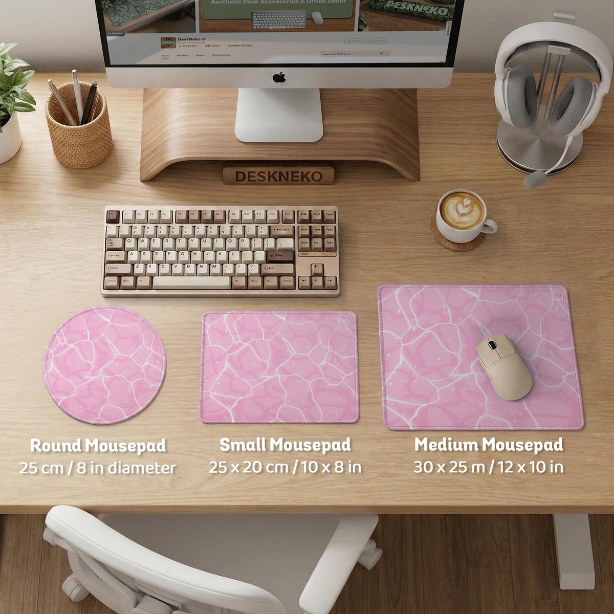 Pastel pink desk mat with a marble-style design, white flowing lines, and small sparkle accents.