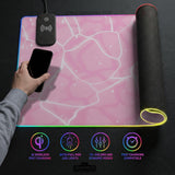 Pastel pink desk mat with a marble-style design, white flowing lines, and small sparkle accents.