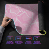 Pastel pink desk mat with a marble-style design, white flowing lines, and small sparkle accents.