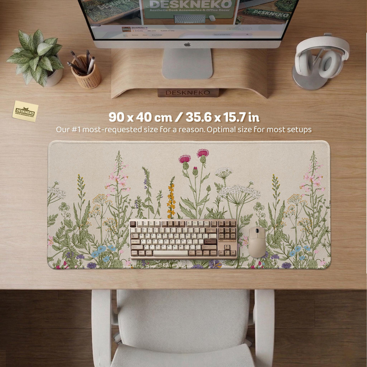 A desk mat with a botanical meadow design featuring wildflowers, leafy stems, and soft neutral colors.