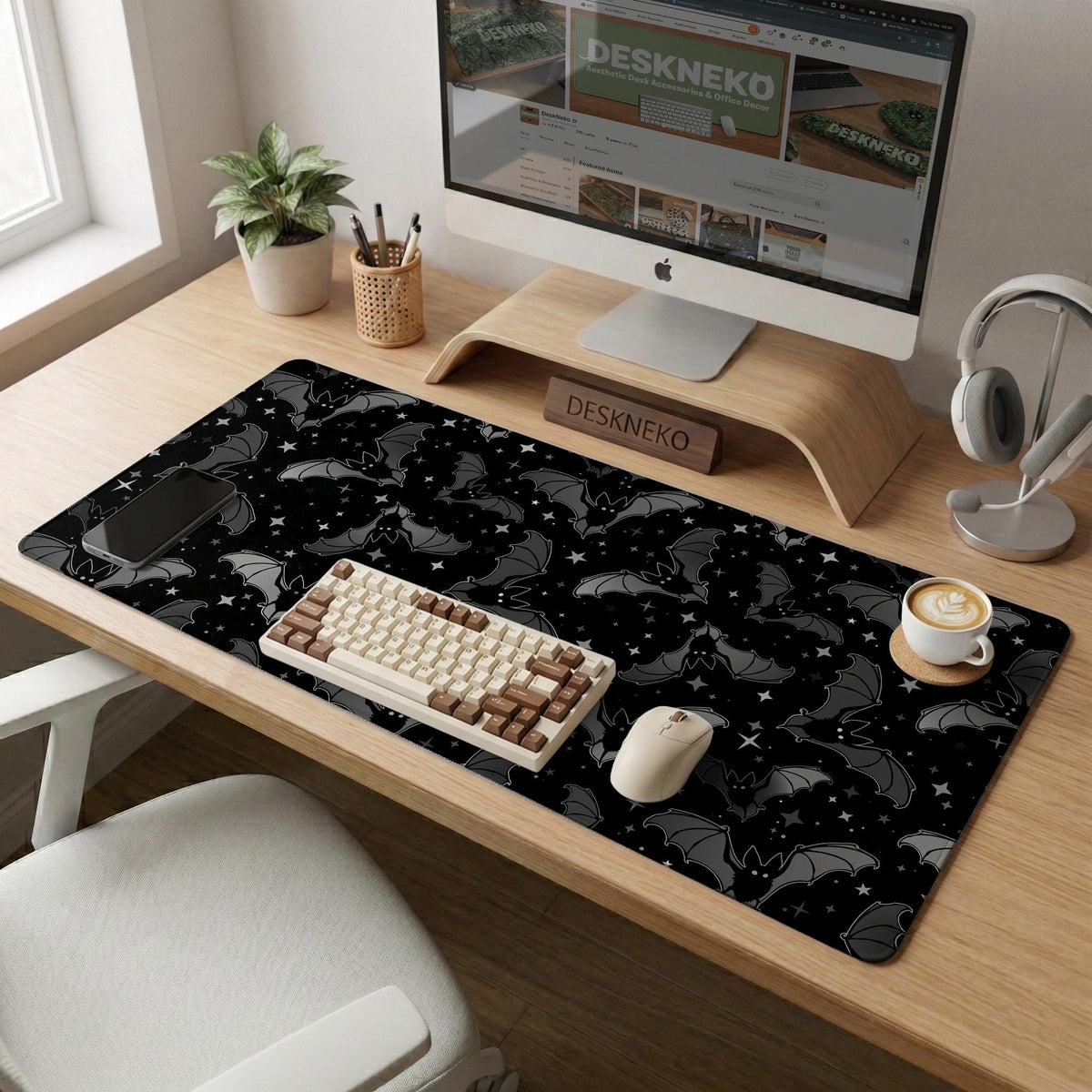 Black desk mat with a dark bat pattern and scattered stars on a charcoal background.