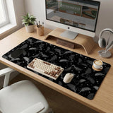 Black desk mat with a dark bat pattern and scattered stars on a charcoal background.