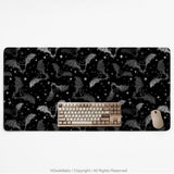 Black desk mat with a dark bat pattern and scattered stars on a charcoal background.