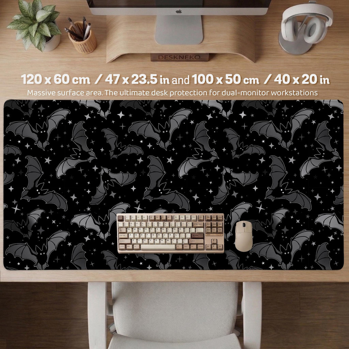 Black desk mat with a dark bat pattern and scattered stars on a charcoal background.