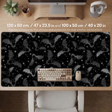 Black desk mat with a dark bat pattern and scattered stars on a charcoal background.