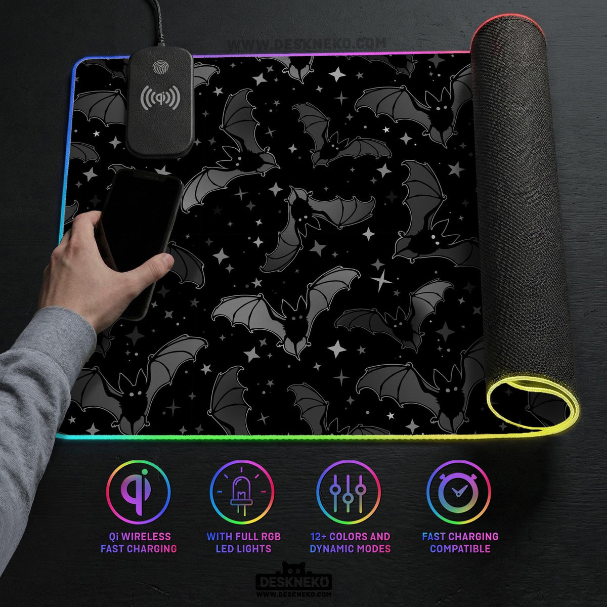 Black desk mat with a dark bat pattern and scattered stars on a charcoal background.