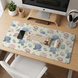 Floral desk mat with sage greenery, pink peonies, blue flowers, and a warm cream background.