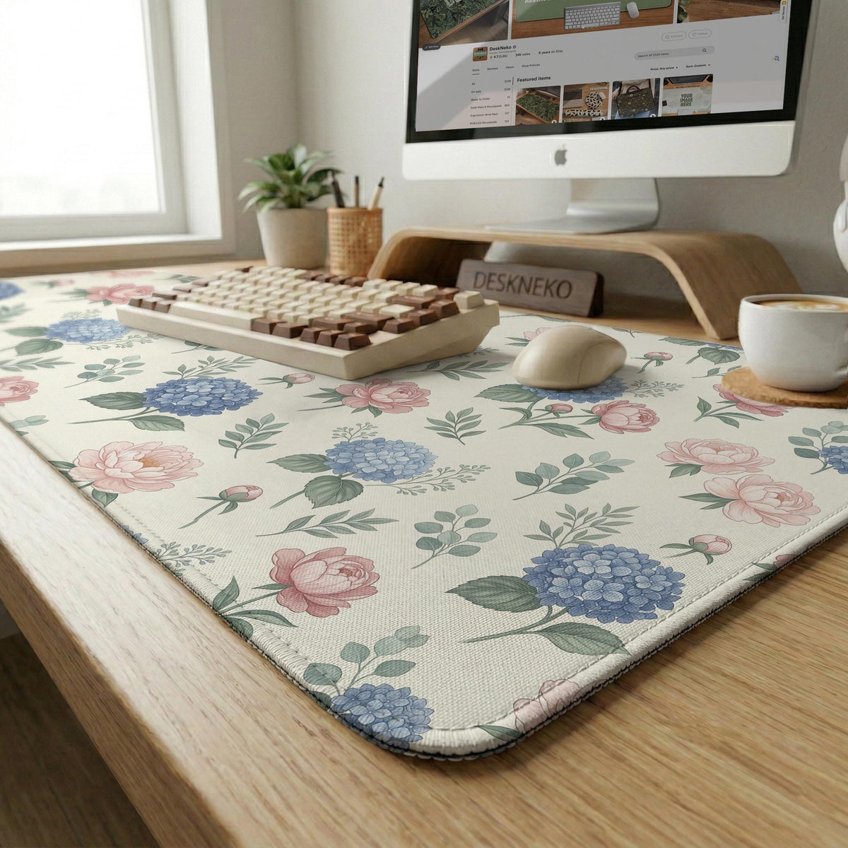 Floral desk mat with sage greenery, pink peonies, blue flowers, and a warm cream background.