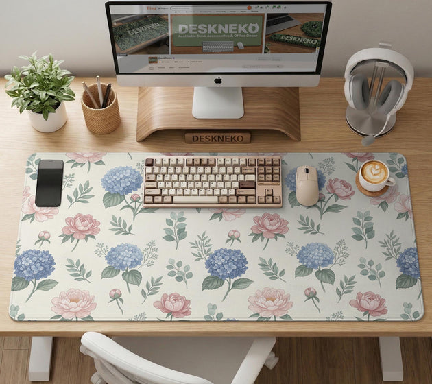 Floral desk mat with sage greenery, pink peonies, blue flowers, and a warm cream background.