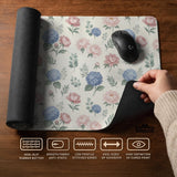 Floral desk mat with sage greenery, pink peonies, blue flowers, and a warm cream background.