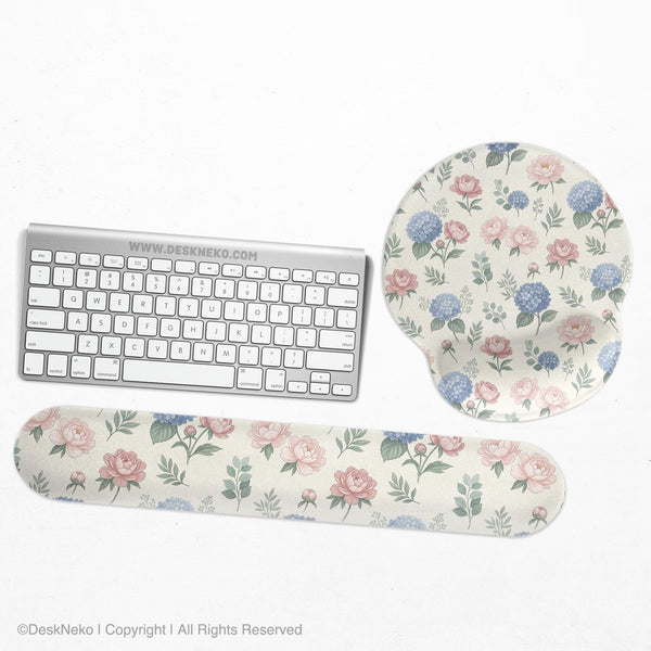Mousepad and keyboard wrist rest with a floral print of blue hydrangeas, pink peonies, sage leaves, and a cream background.