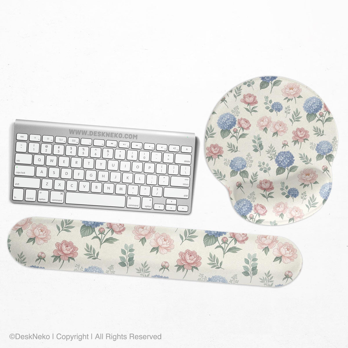 Mousepad and keyboard wrist rest with a floral print of blue hydrangeas, pink peonies, sage leaves, and a cream background.