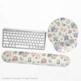 Mousepad and keyboard wrist rest with a floral print of blue hydrangeas, pink peonies, sage leaves, and a cream background.