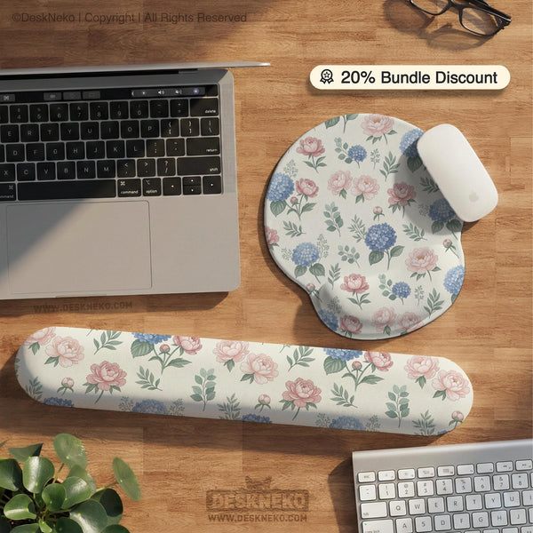 Mousepad and keyboard wrist rest with a floral print of blue hydrangeas, pink peonies, sage leaves, and a cream background.