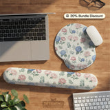 Mousepad and keyboard wrist rest with a floral print of blue hydrangeas, pink peonies, sage leaves, and a cream background.