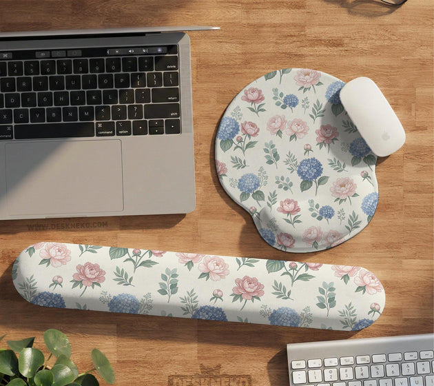 Mousepad and keyboard wrist rest with a floral print of blue hydrangeas, pink peonies, sage leaves, and a cream background.
