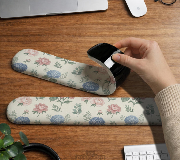 Mousepad and keyboard wrist rest with a floral print of blue hydrangeas, pink peonies, sage leaves, and a cream background.