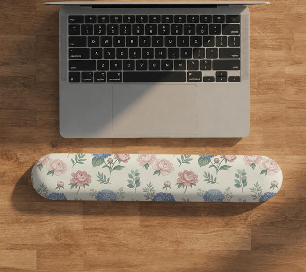 Mousepad and keyboard wrist rest with a floral print of blue hydrangeas, pink peonies, sage leaves, and a cream background.