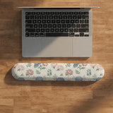 Mousepad and keyboard wrist rest with a floral print of blue hydrangeas, pink peonies, sage leaves, and a cream background.