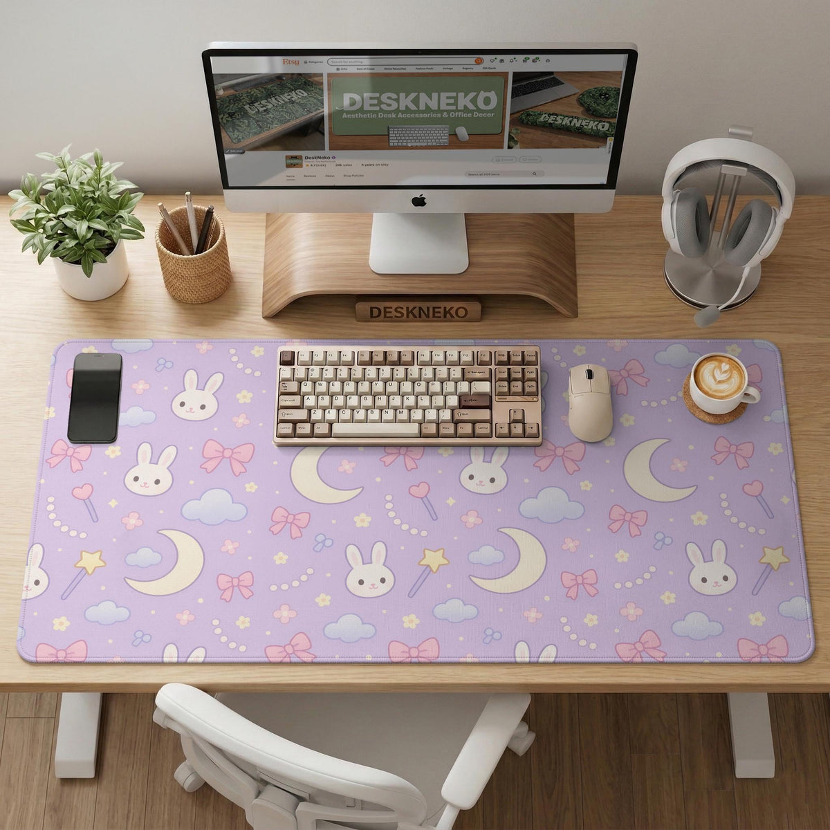 Lavender desk mat with an all-over pattern of bunny faces, clouds, moons, bows, and flowers in pastel colors.