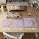 Pastel lavender desk mat with an all-over pattern of bunnies, crescent moons, clouds, bows, stars, and small flowers.