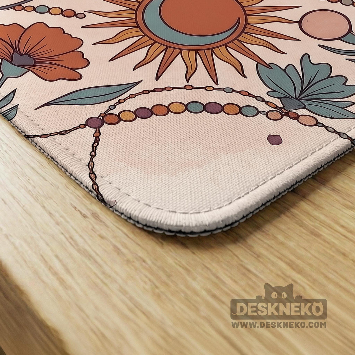 A square mahjong mat with a scalloped edge, sun and moon artwork, terracotta flowers, a soft cream background, and a decorative border around the play area.
