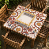 A square mahjong mat with a scalloped edge, sun and moon artwork, terracotta flowers, a soft cream background, and a decorative border around the play area.