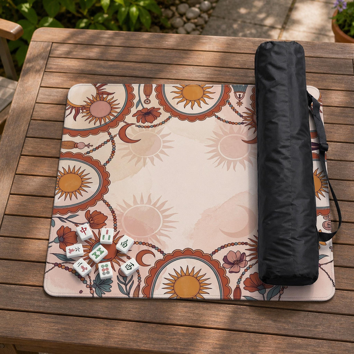 A square mahjong mat with a scalloped edge, sun and moon artwork, terracotta flowers, a soft cream background, and a decorative border around the play area.
