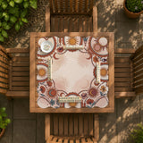 A square mahjong mat with a scalloped edge, sun and moon artwork, terracotta flowers, a soft cream background, and a decorative border around the play area.