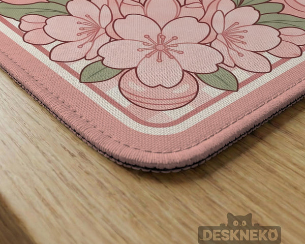 Pink gingham mahjong mat with a floral border, cherry blossom details, and a bow design around a plain center play area.