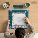 Blue and white square mahjong mat with a koi fish and lotus border design and a plain center area.