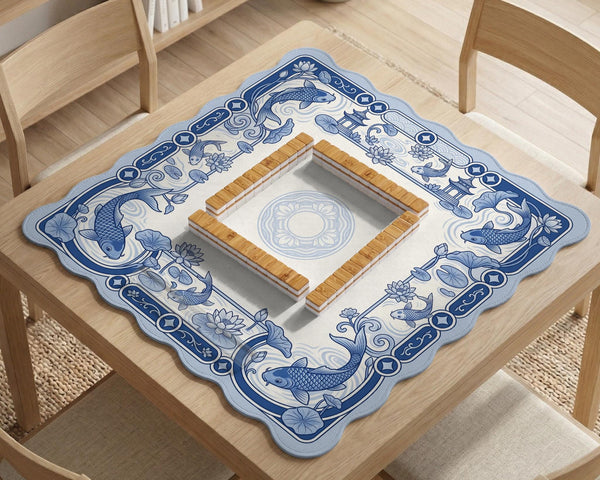 Navy blue square mahjong table mat with lotus flowers and koi fish in a porcelain-style border and a plain center.