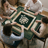 Square emerald green mahjong mat with bamboo line art, gold geometric cloud shapes, and a plain center playing area.