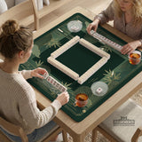 Square emerald green mahjong mat with bamboo line art, gold geometric cloud shapes, and a plain center playing area.