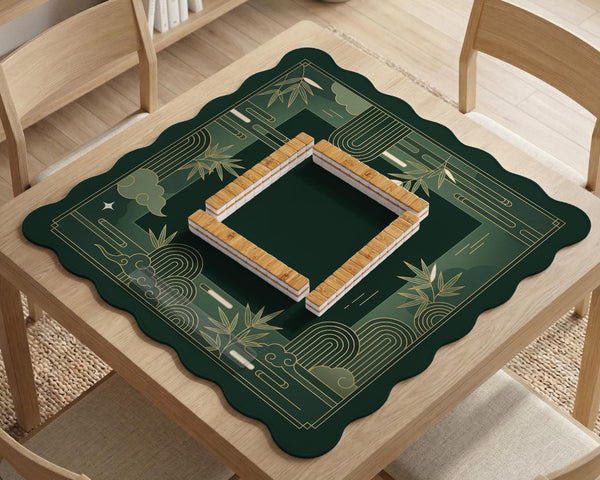 Square emerald green mahjong mat with bamboo line art, gold geometric cloud shapes, and a plain center playing area.