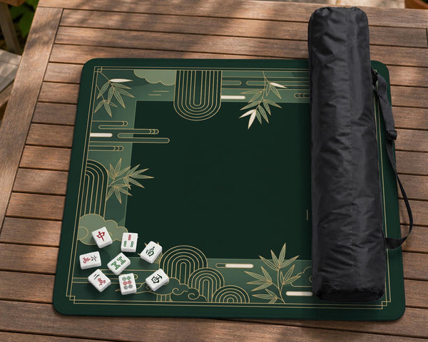Square emerald green mahjong mat with bamboo line art, gold geometric cloud shapes, and a plain center playing area.