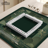 Square emerald green mahjong mat with bamboo line art, gold geometric cloud shapes, and a plain center playing area.