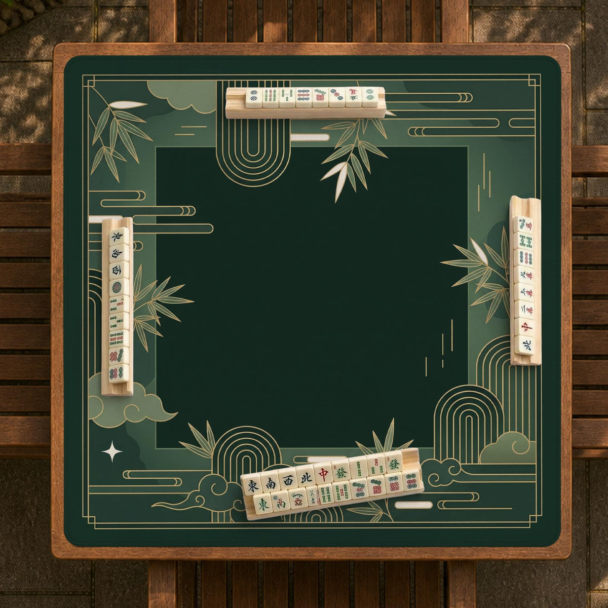 Square emerald green mahjong mat with bamboo line art, gold geometric cloud shapes, and a plain center playing area.