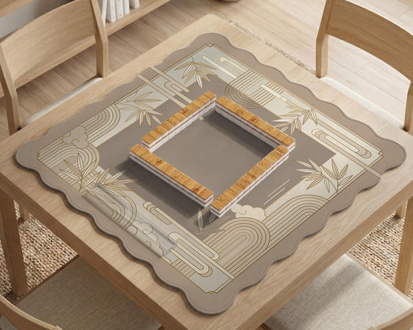 Beige and gold square mahjong mat with a bamboo pattern and geometric border.