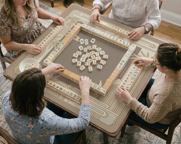 Beige and gold square mahjong mat with a bamboo pattern and geometric border.