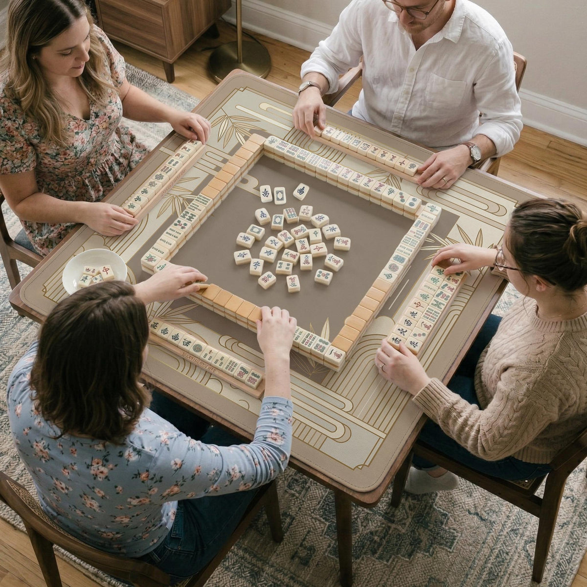 Beige and gold square mahjong mat with a bamboo pattern and geometric border.