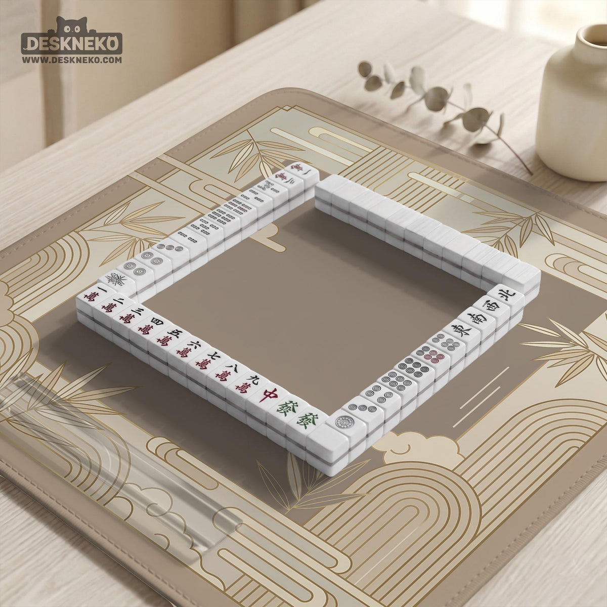 Beige and gold square mahjong mat with a bamboo pattern and geometric border.